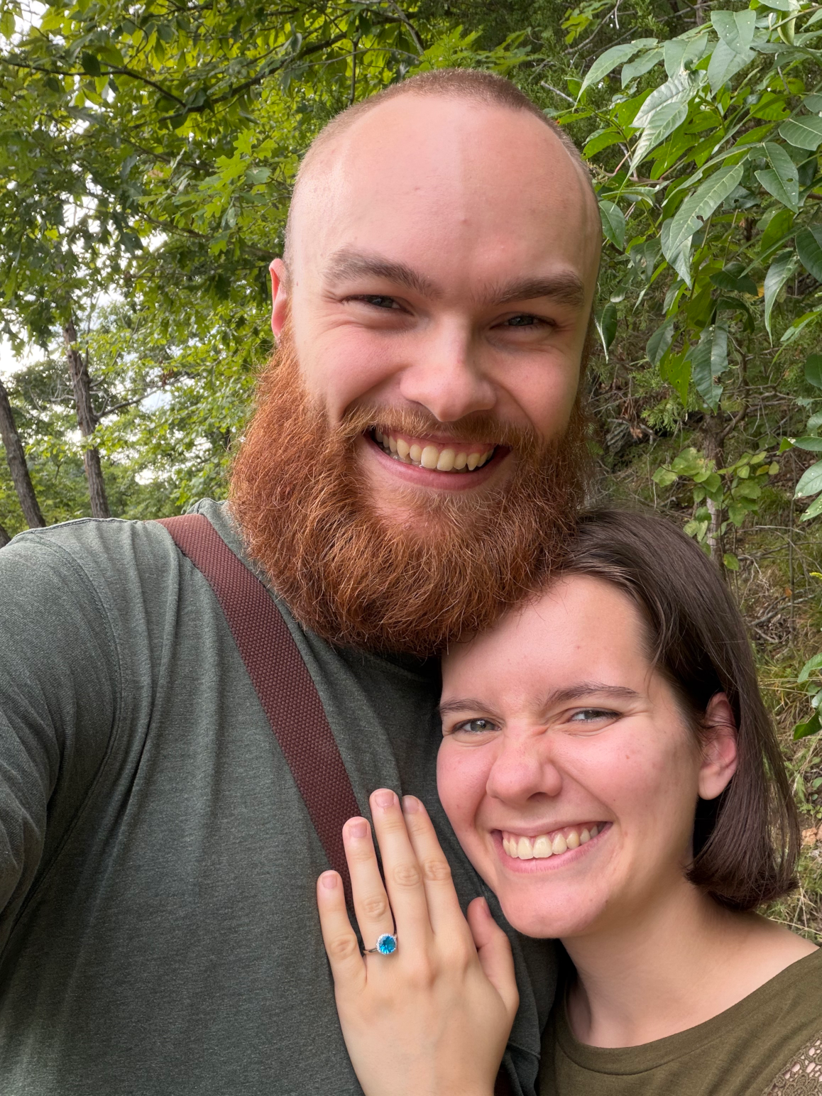Nathan Swanstrom and Jeannie Fagg celebrating their engagement outdoors